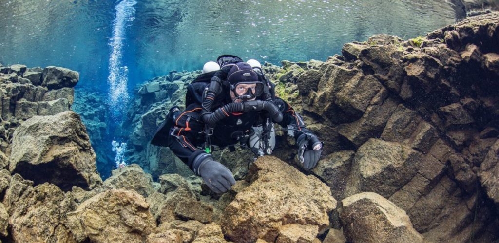 Diver practising their rebreather skills. In this image buoyancy. The diver has just started their dive at Silfra Fissure in Iceland.