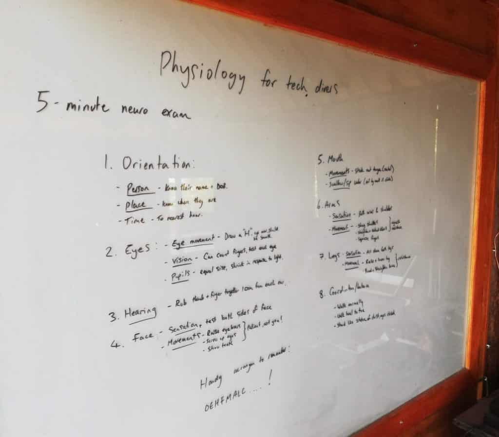 Whiteboard showing notes on diving physiology. Here the 5 minute neuro exam