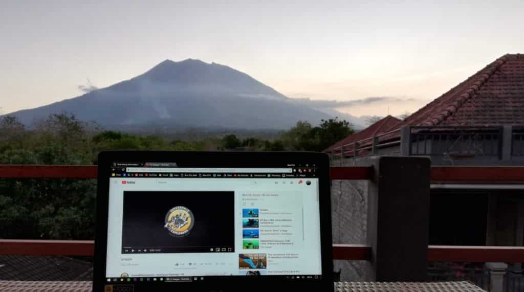 Viewing Innerspace Explorers skills on a laptop, as Bali's Mount Agung sits in the background just prior to sunset