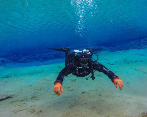 The author of many Scuba Diver Life articles faces the camera in the lagoon at Silfra Fissure in Iceland. This dive site is famous for having exceptional underwater visibility, which is visible here