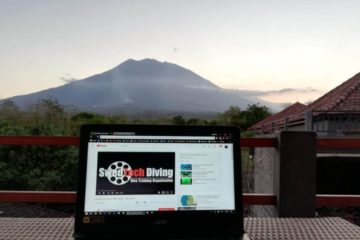 Viewing Swedtech skills on a laptop, as Bali's Mount Agung sits in the background just prior to sunset