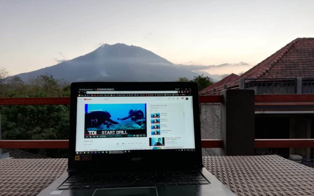 Viewing TDI skills on a laptop as the sun is about to set. Bali's Mount Agung in the background.
