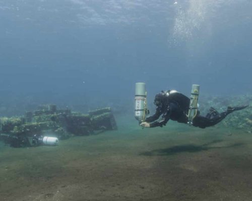 Diver cleaning up their decompression cylinders after undertaking doing some tech fun diving